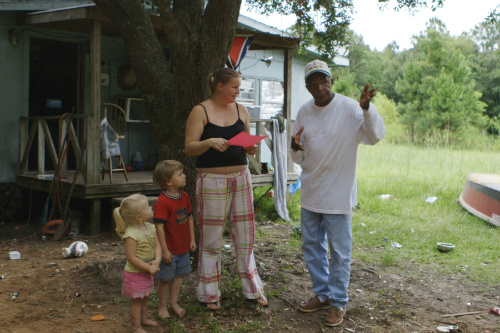 Roosevelt Harris talking to a woman in The Great Invisible